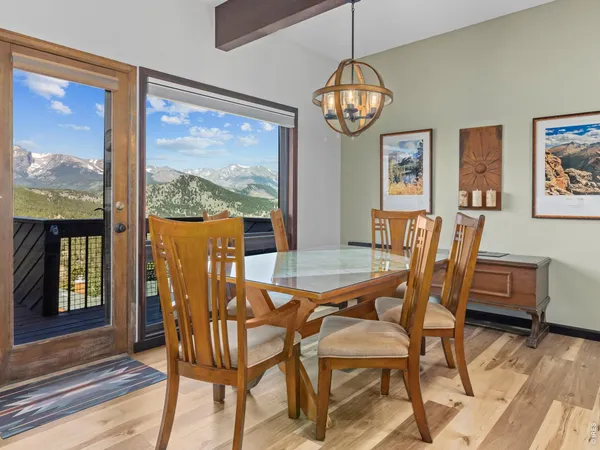 a view of a dining room with furniture wooden floor and chandelier