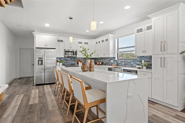 a view of kitchen with cabinets and wooden floor
