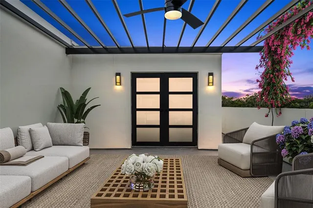 a living room with furniture and a potted plant