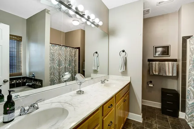 a bathroom with a double vanity sink and a mirror