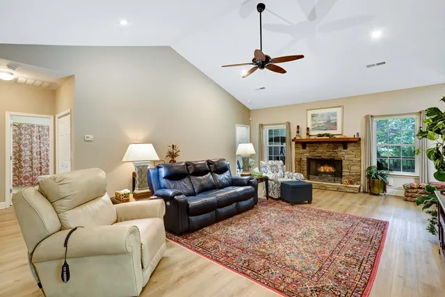 a living room with furniture a window and a fireplace