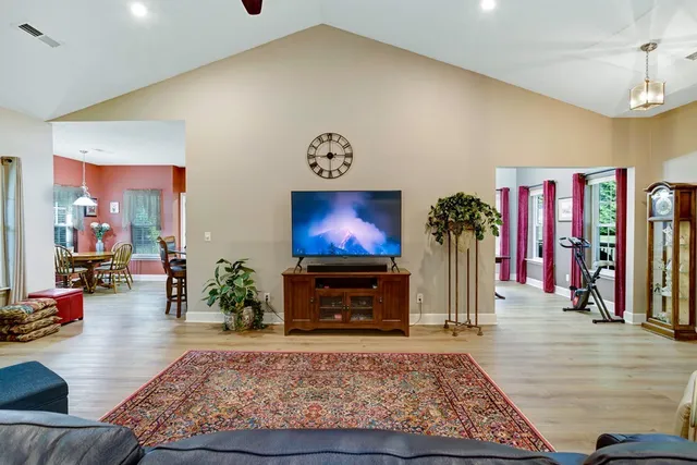 a living room with furniture rug and a flat screen tv