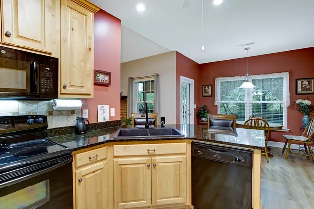 a kitchen with a sink stove and cabinets