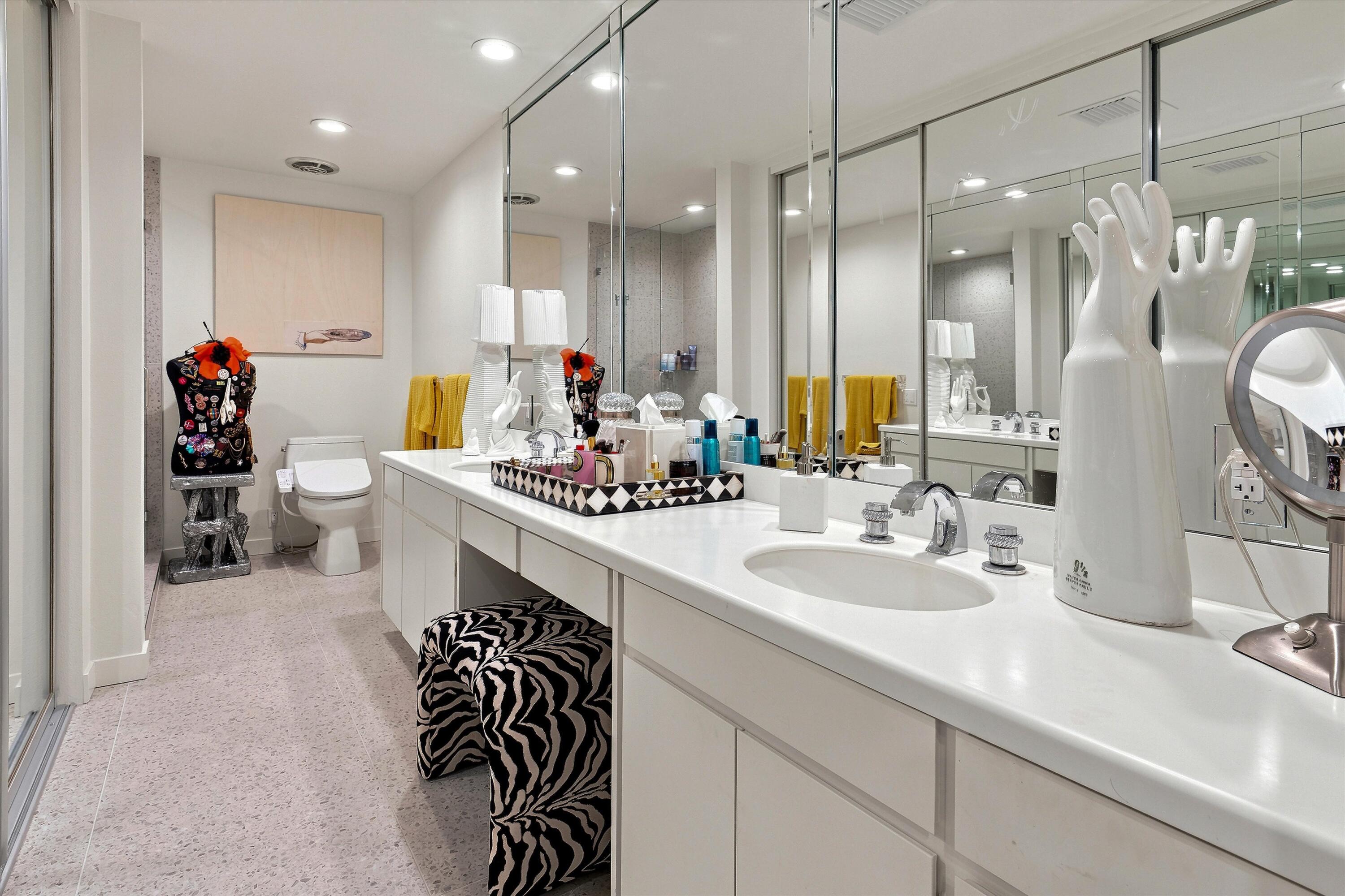 899 Island Drive, Unit 304 Rancho Mirage, CA 92270 - Photo 19 of 30 a bathroom with a double vanity sink mirror and toilet