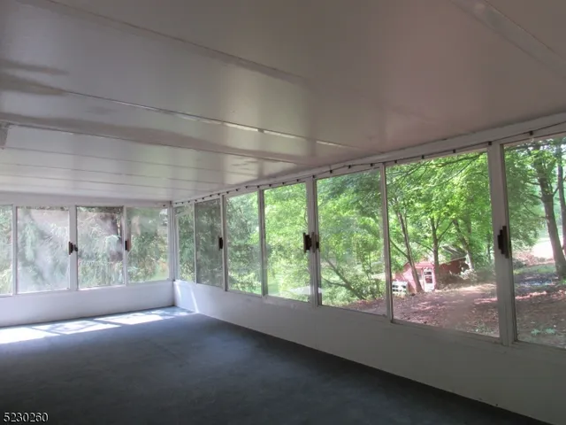 a view of room with green walls and floor to ceiling window