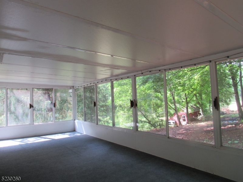 275 Creek Road Frenchtown, NJ 08825 - Photo 2 of 27 a view of room with green walls and floor to ceiling window