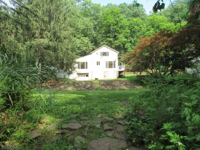 a house with green field in front of it