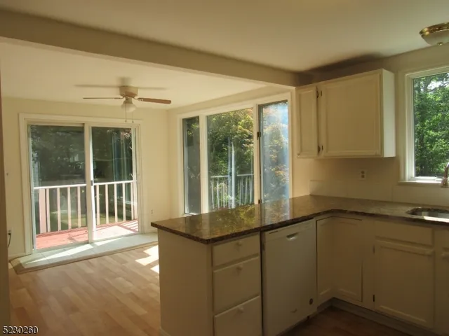 a view of a kitchen with a sink and windows