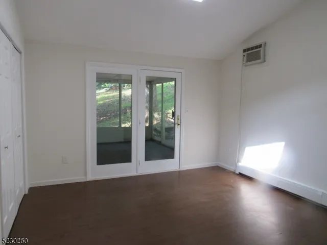 a view of empty room with floor to ceiling window