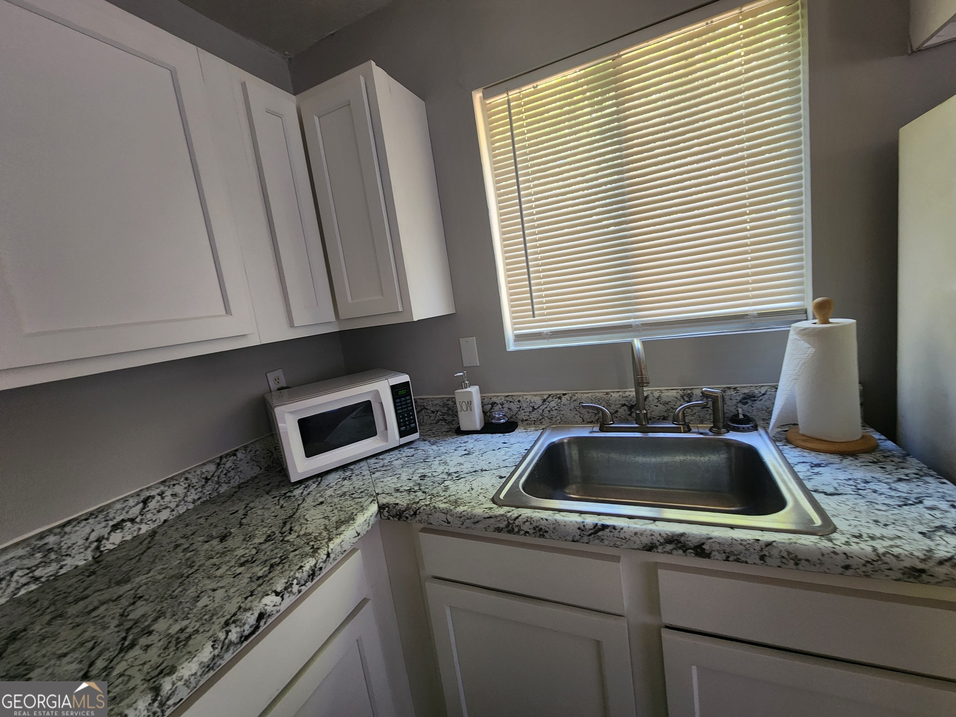 917 Oakview Avenue, Unit D Columbus, GA 31906 - Photo 8 of 13 a kitchen that has a sink and a window