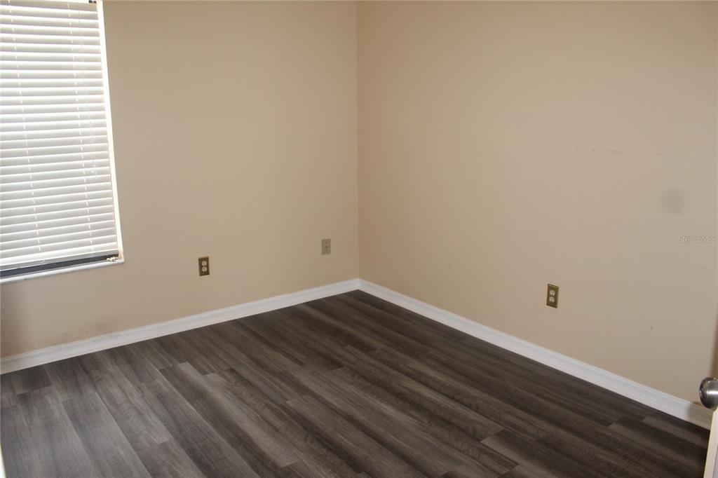 9869 Aloma Bend Lane Oviedo, FL 32765 - Photo 11 of 15 a room with wooden floor and window