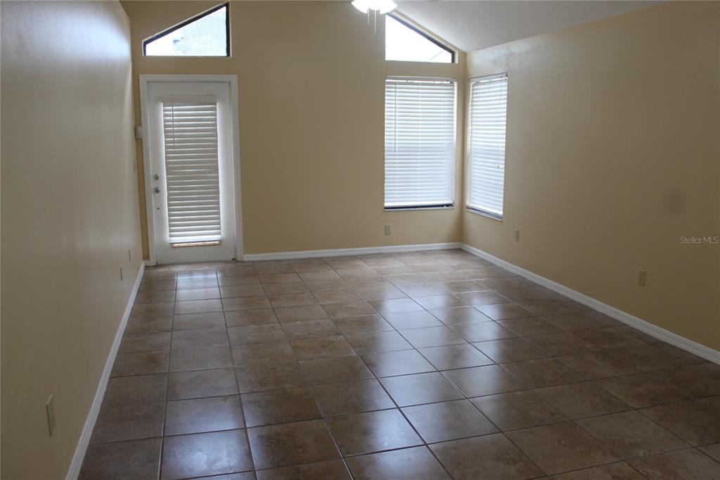 9869 Aloma Bend Lane Oviedo, FL 32765 - Photo 6 of 15 a view of an empty room with a window