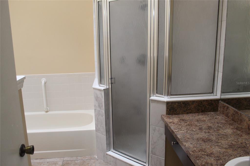 9869 Aloma Bend Lane Oviedo, FL 32765 - Photo 9 of 15 a bathroom with a granite countertop sink and a bathtub