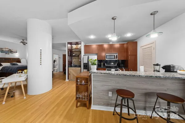 a large kitchen with a table and chairs