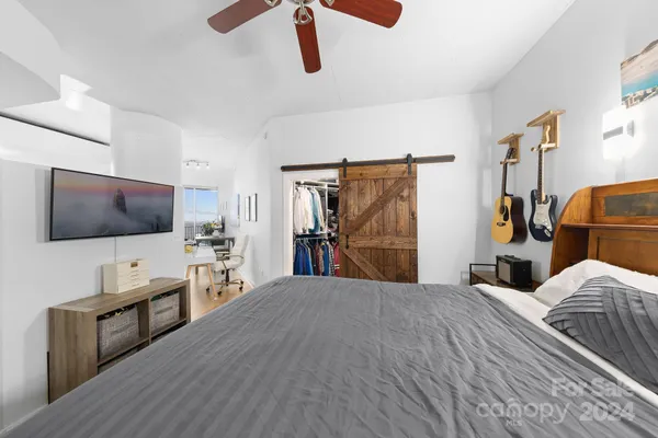 a bedroom with furniture and flat screen tv