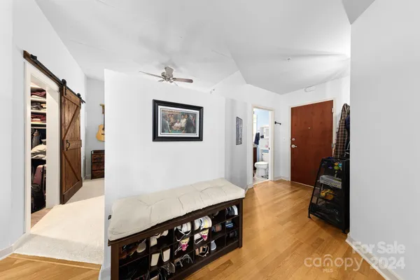 a view of a living room with furniture and a flat screen tv