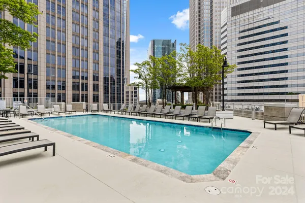 a swimming pool with outdoor seating and yard