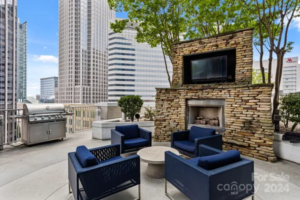 a outdoor space with patio fireplace and a couch