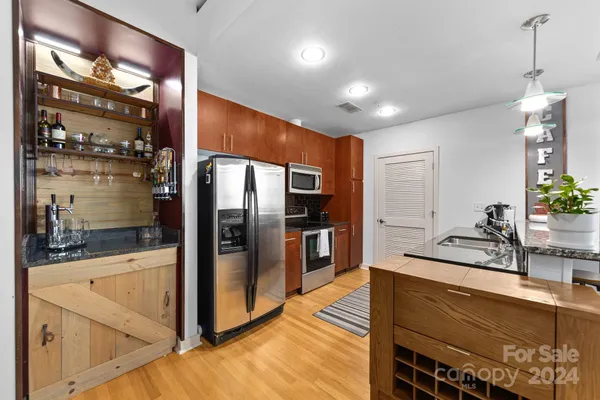 a kitchen with stainless steel appliances a refrigerator and a sink