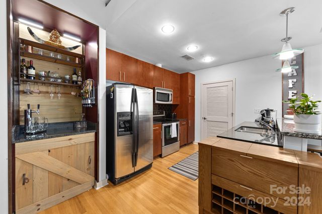 a kitchen with stainless steel appliances a refrigerator and a sink
