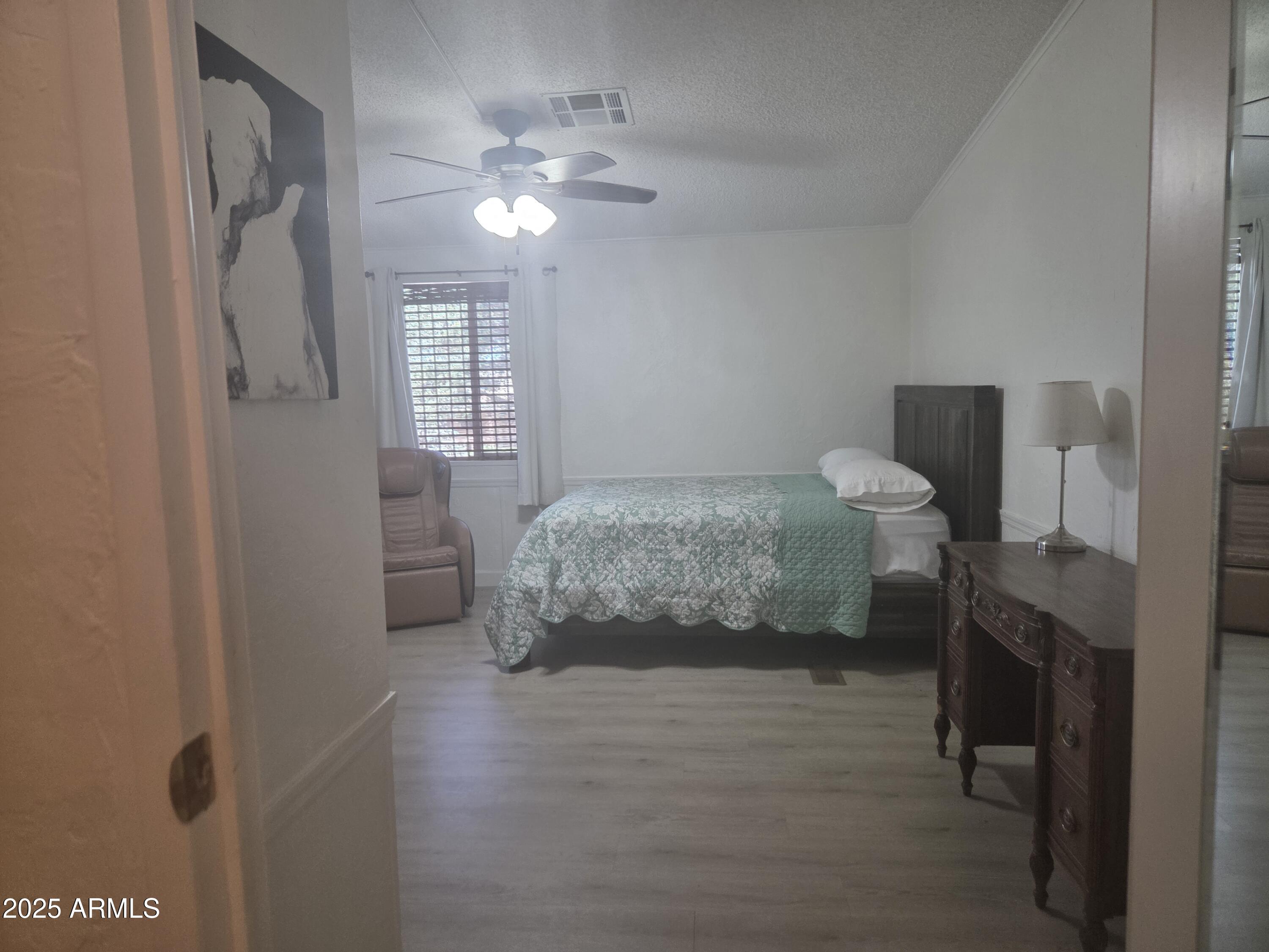 115 South Young Road Payson, AZ 85541 - Photo 16 of 34 a bedroom with a bed and a chandelier