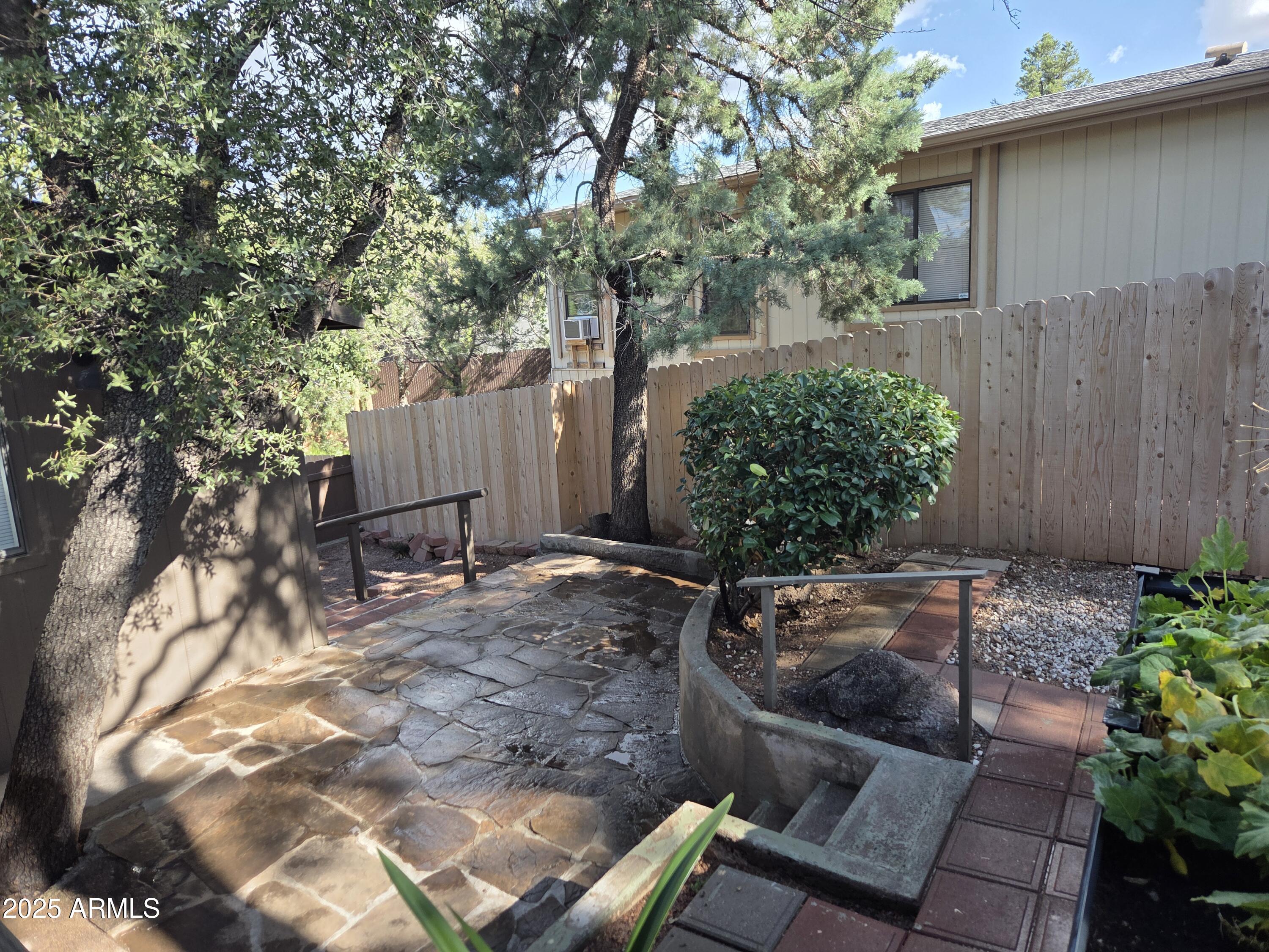 115 South Young Road Payson, AZ 85541 - Photo 29 of 34 a view of a backyard with table and chairs potted plants and large tree