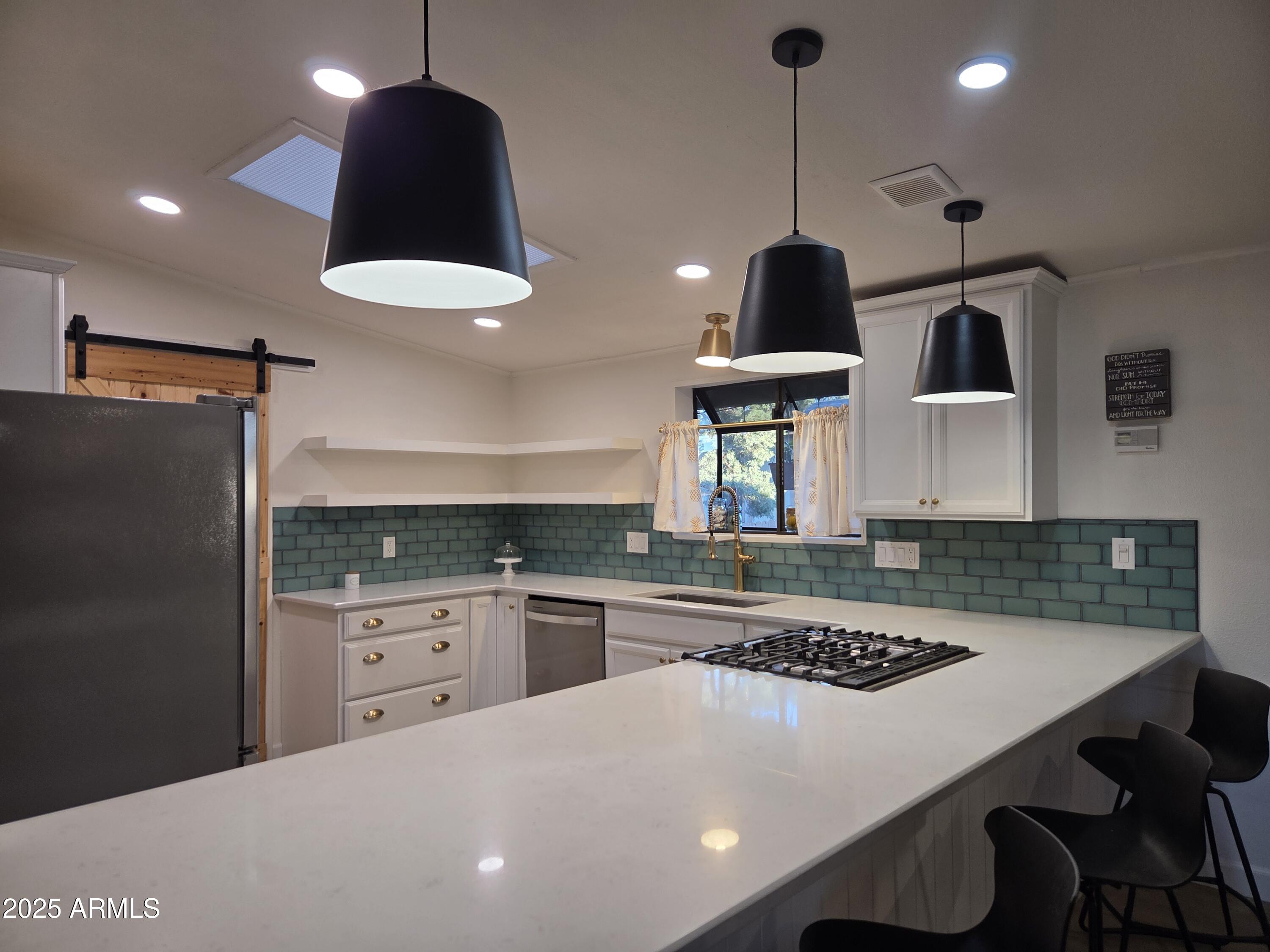 115 South Young Road Payson, AZ 85541 - Photo 4 of 34 a kitchen with stainless steel appliances granite countertop a sink a stove a refrigerator and island