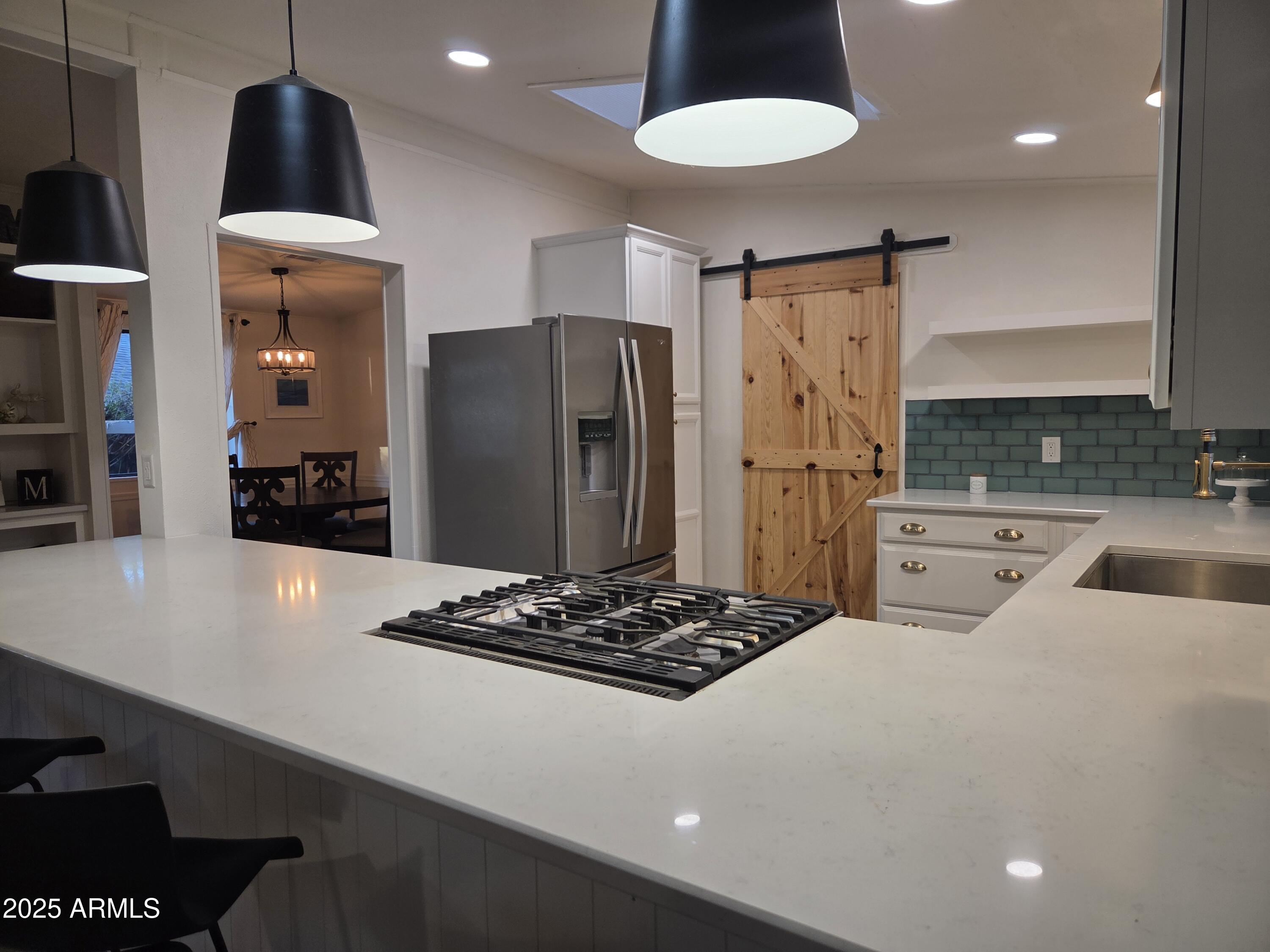 115 South Young Road Payson, AZ 85541 - Photo 5 of 34 a kitchen with stainless steel appliances a refrigerator a stove a sink dishwasher and a stove with wooden floor