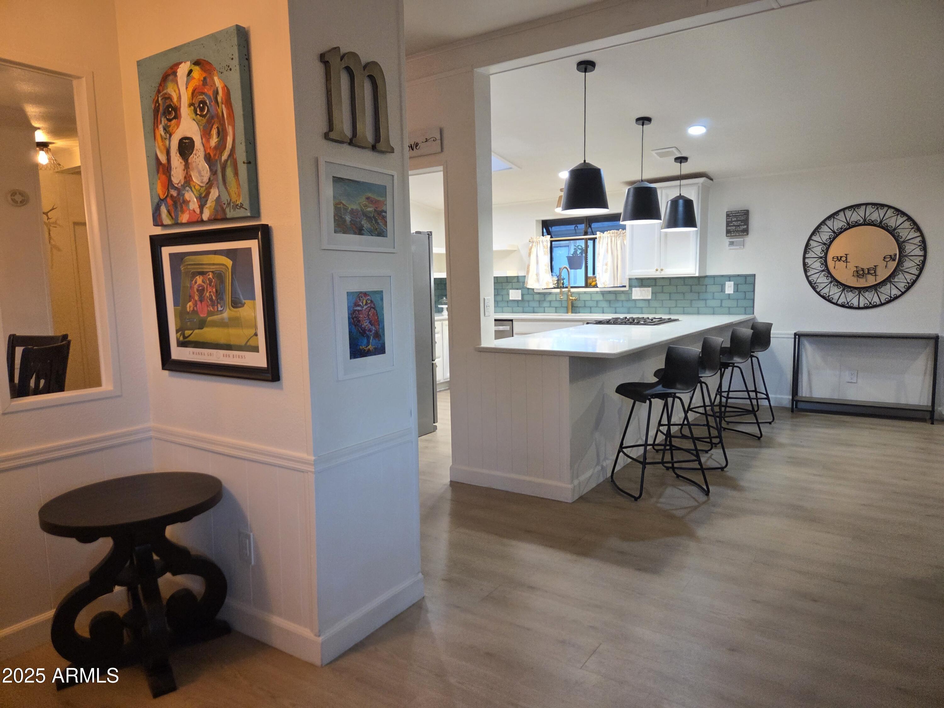 115 South Young Road Payson, AZ 85541 - Photo 6 of 34 a kitchen with stainless steel appliances granite countertop a stove a refrigerator and a dining table with wooden floor