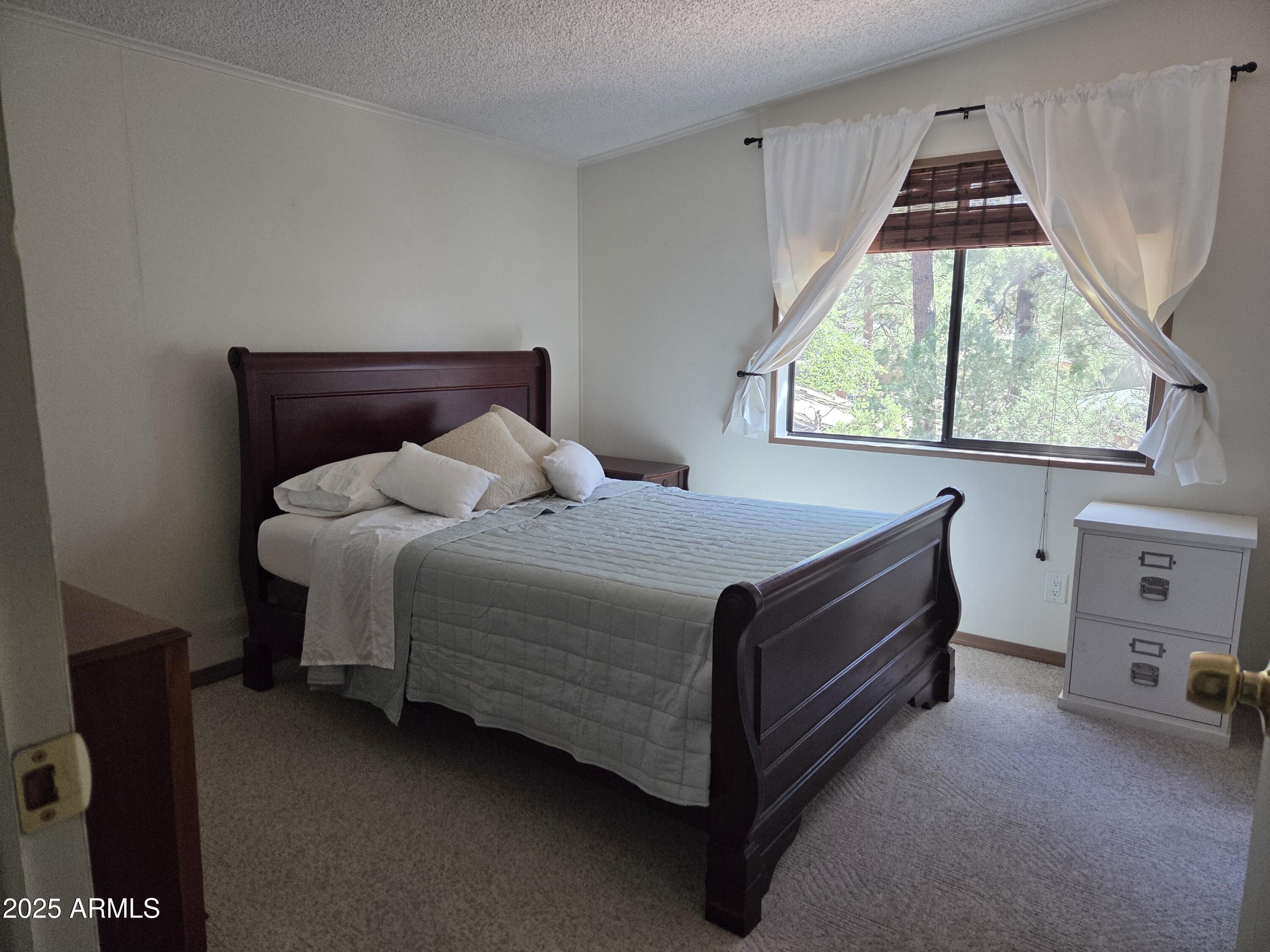 115 South Young Road Payson, AZ 85541 - Photo 9 of 34 a bed sitting in a room next to a window