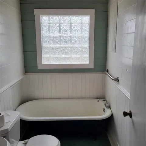 a bathroom with a sink a toilet and a bath tub
