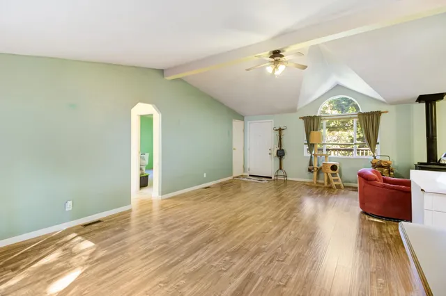 a living room with furniture window and wooden floor