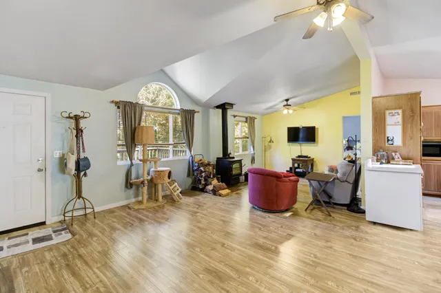 a living room with furniture a flat screen tv and a window