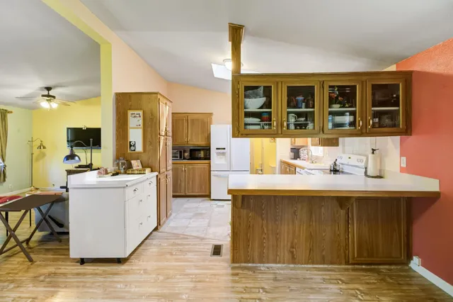 a kitchen with a sink stove and refrigerator
