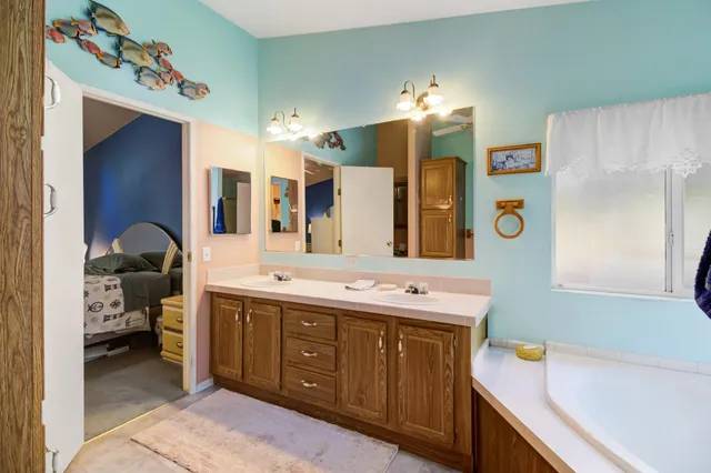 a view of a hallway view with wooden floor and a chandelier