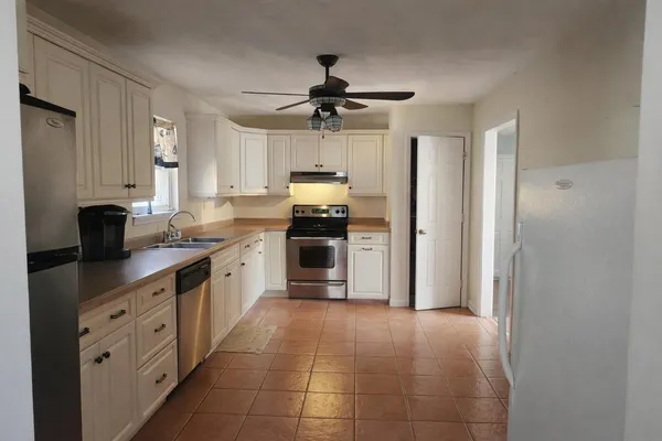 a kitchen with a refrigerator a sink and dishwasher