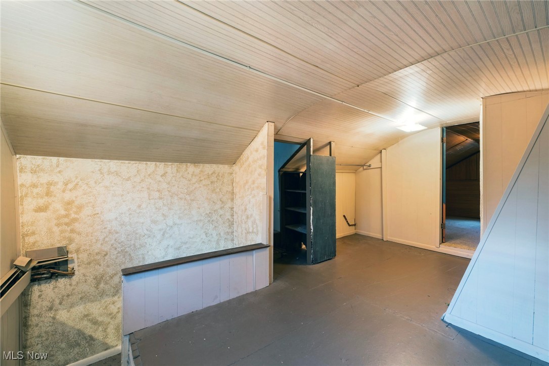 6050 Shaffer Road Northwest Warren, OH 44481 - Photo 24 of 39 Additional living space with concrete floors and vaulted ceiling