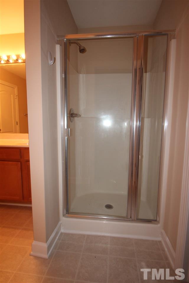 3112 Trassacks Drive Raleigh, NC 27610 - Photo 13 of 13 a bathroom with a glass shower door