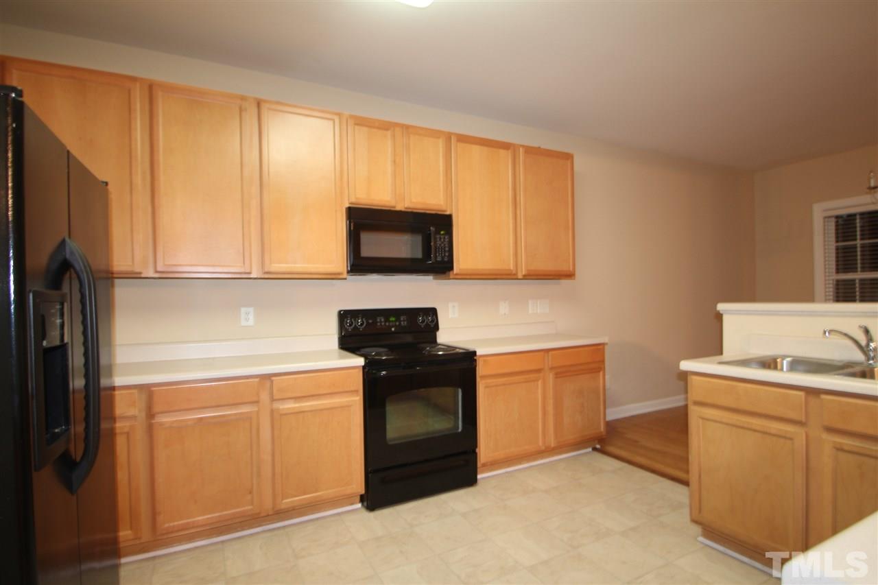 3112 Trassacks Drive Raleigh, NC 27610 - Photo 3 of 13 a kitchen with a sink stove and microwave