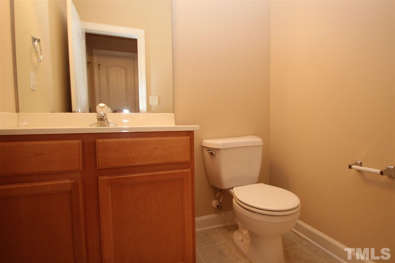 3112 Trassacks Drive Raleigh, NC 27610 - Photo 6 of 13 a bathroom with a granite countertop toilet and a sink