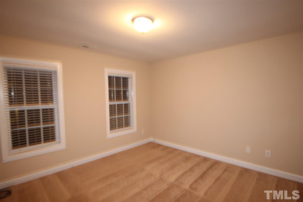 3112 Trassacks Drive Raleigh, NC 27610 - Photo 7 of 13 a view of an empty room with a window
