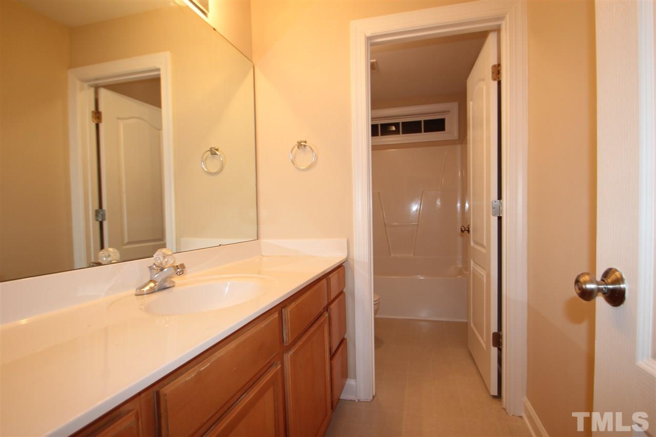 3112 Trassacks Drive Raleigh, NC 27610 - Photo 8 of 13 a bathroom with a sink and a mirror