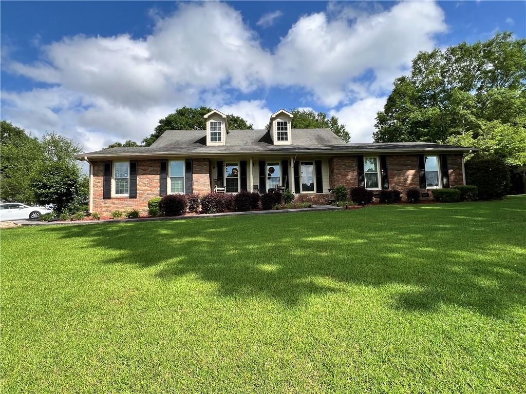 37 Reynolds Bridge Road Kingston, GA 30145 - Photo 1 of 1 a front view of a house with a garden and trees