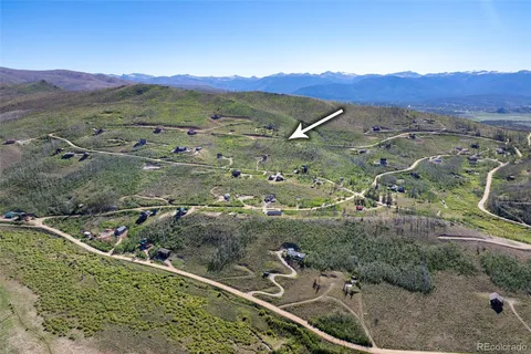 an aerial view of a house with a mountain