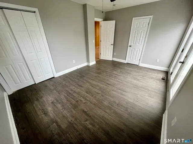 a view of hallway with wooden floor
