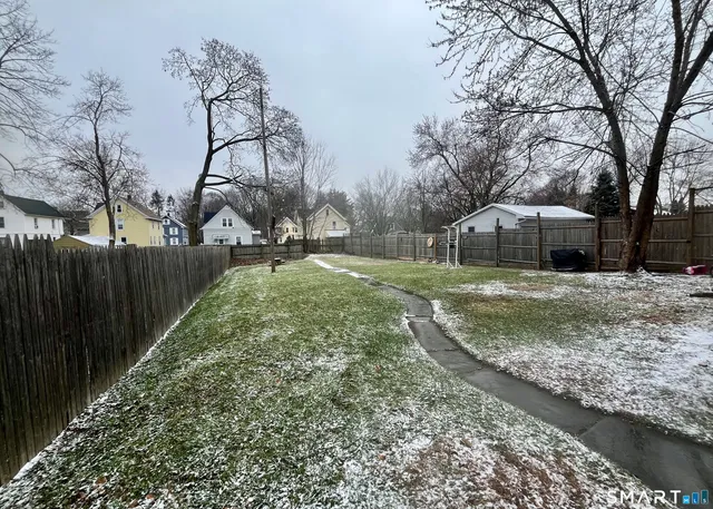 a view of a backyard with large trees