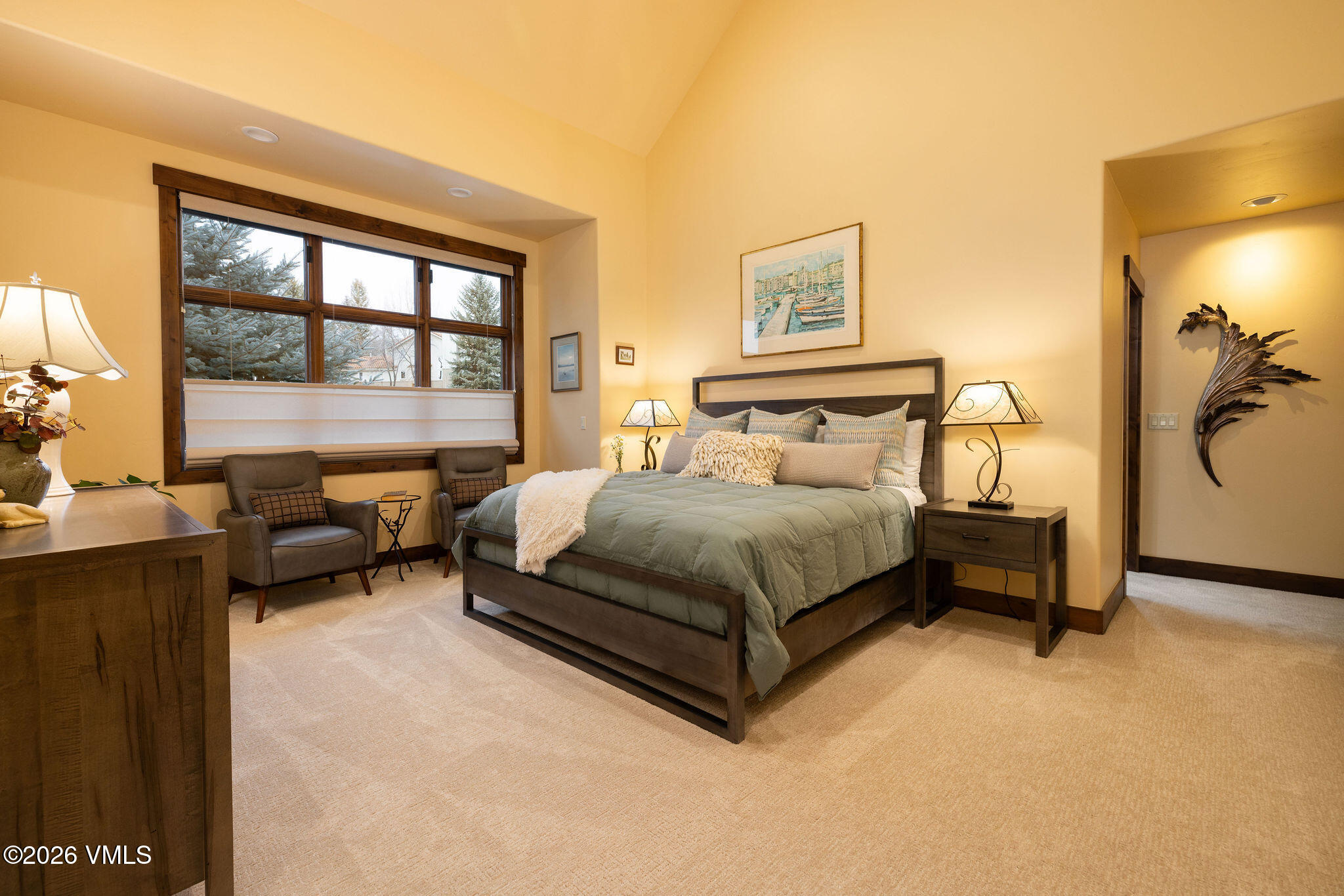 150 Buckboard Road Edwards, CO 81632 - Photo 11 of 27 a bedroom with a bed and a couch next to a window