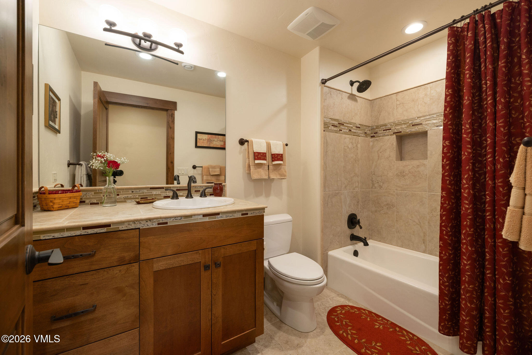 150 Buckboard Road Edwards, CO 81632 - Photo 17 of 27 a bathroom with a granite countertop sink a toilet a mirror a bathtub and shower