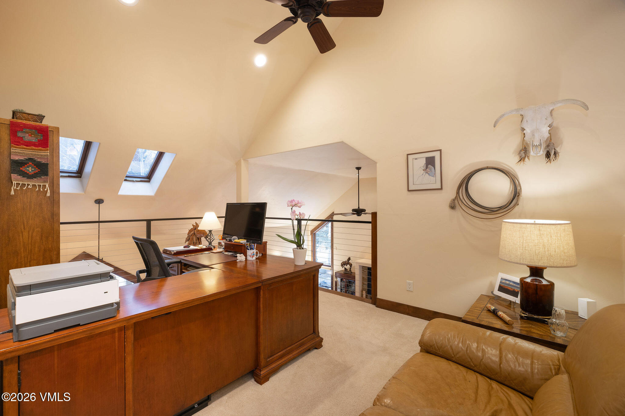 150 Buckboard Road Edwards, CO 81632 - Photo 18 of 27 a living room with couches a computer on a desk and chair