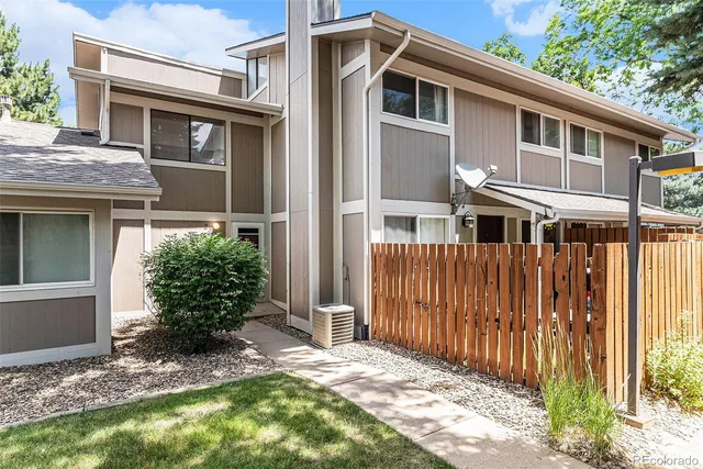 a front view of a house with a yard garage and outdoor seating